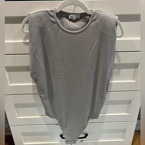 Grey bodysuit has sewn in shoulder pads.